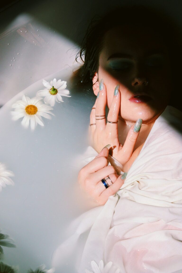 girl with beautiful painted nails having hand on her cheeks