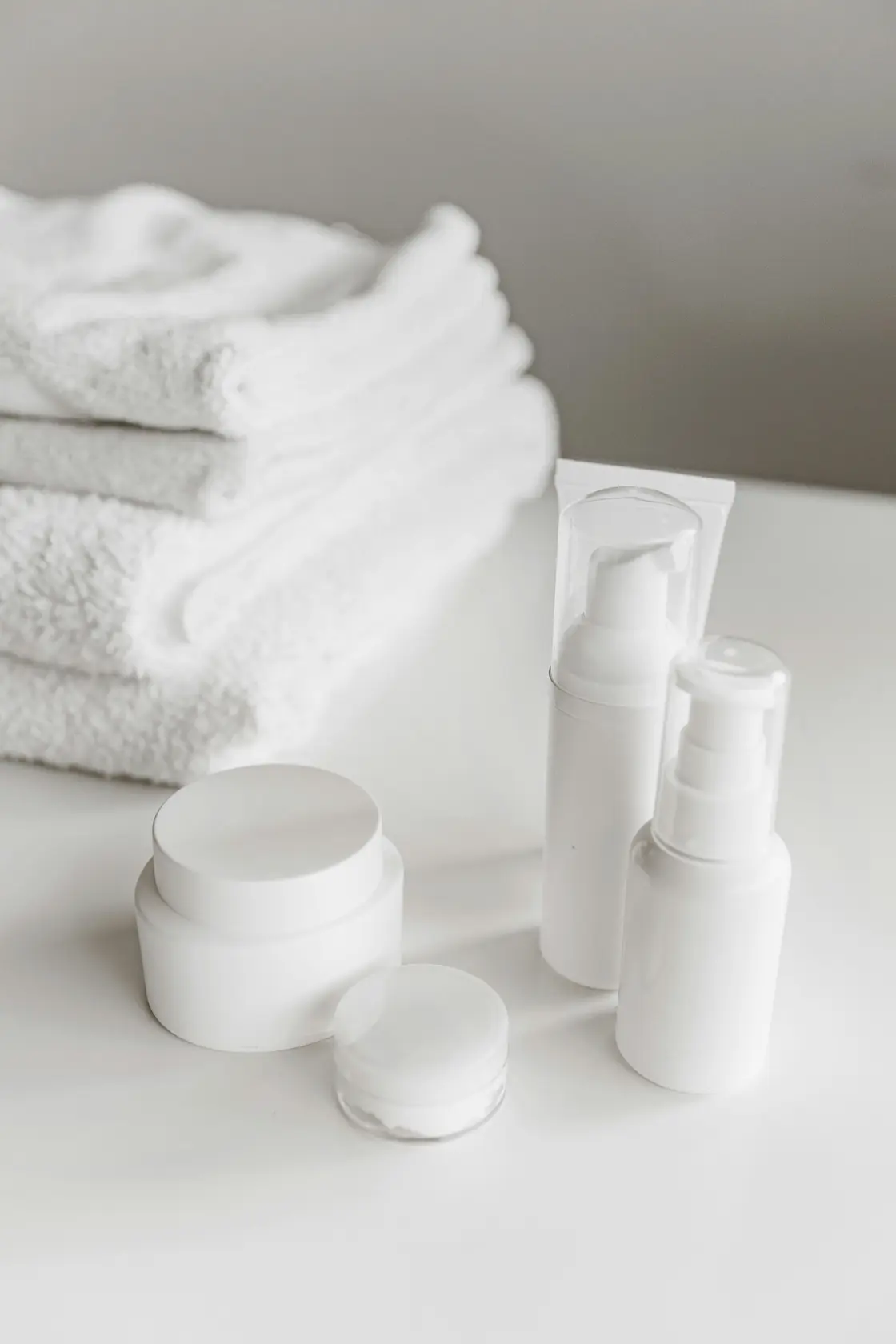woman holding lotion bottle on skin after shower