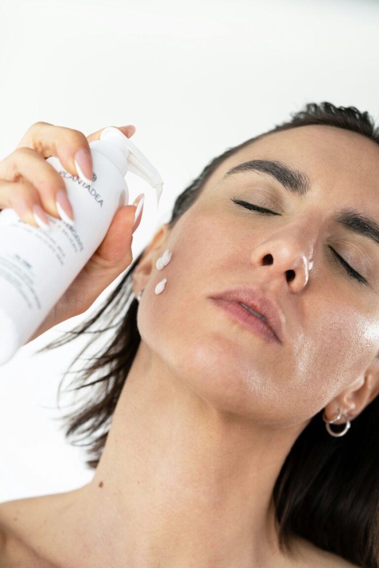 women applying sunscreen on face