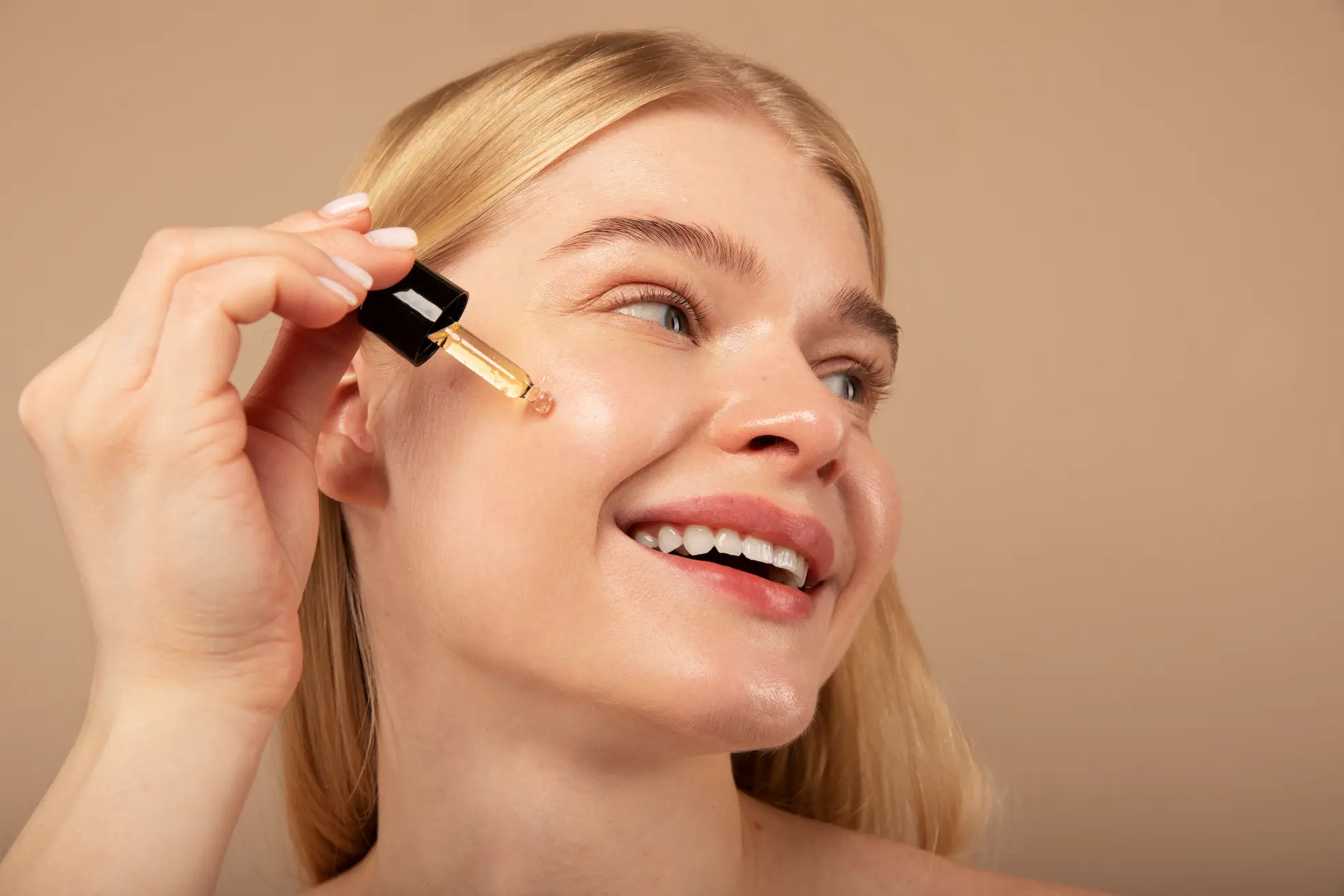 Applying brightening serum to remove dark spots
