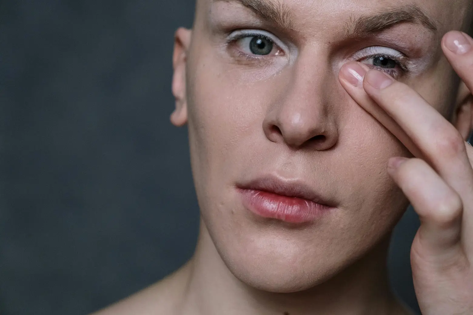 applying creamy concealer to hide dark circles