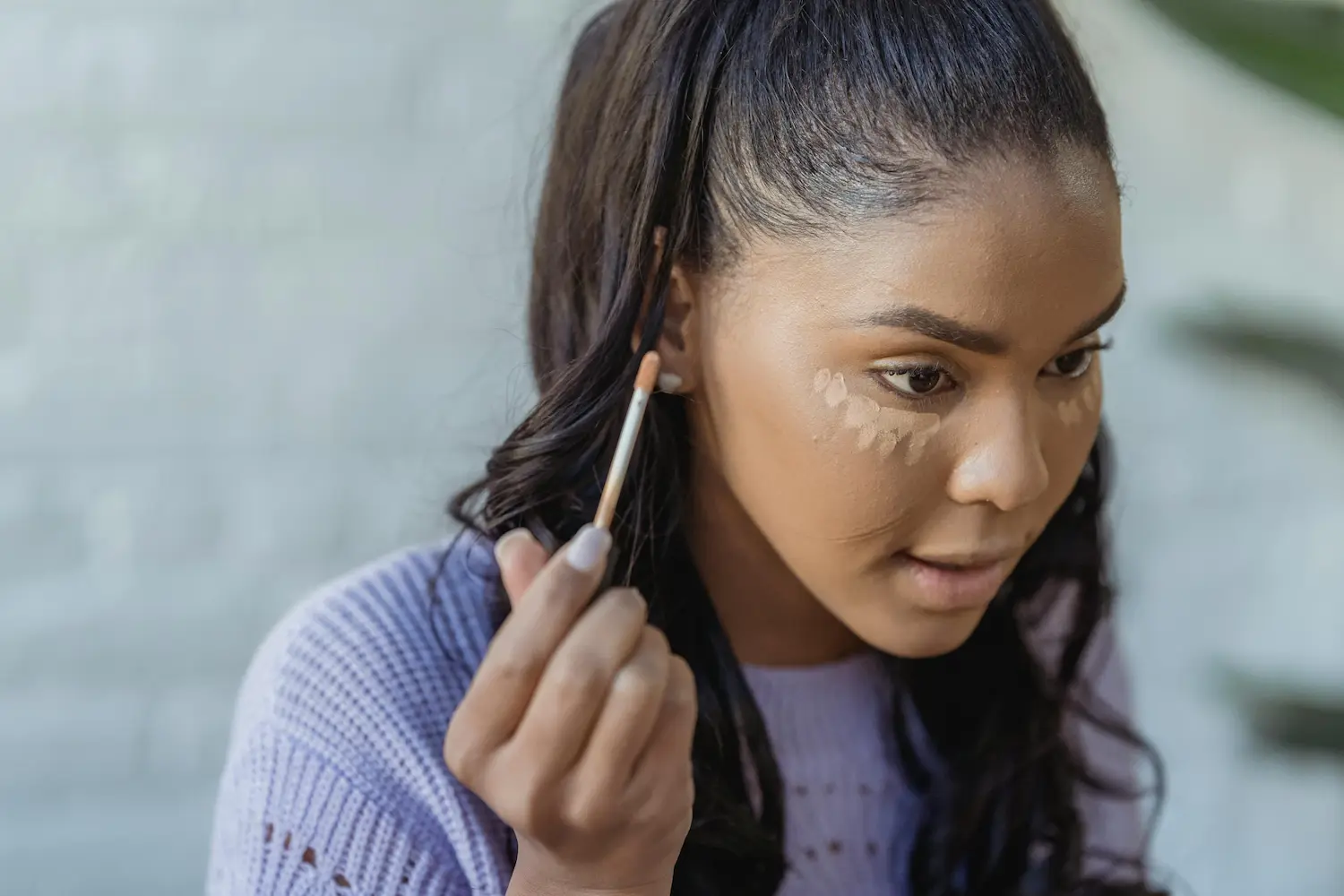 Applying concealer for dark circles
