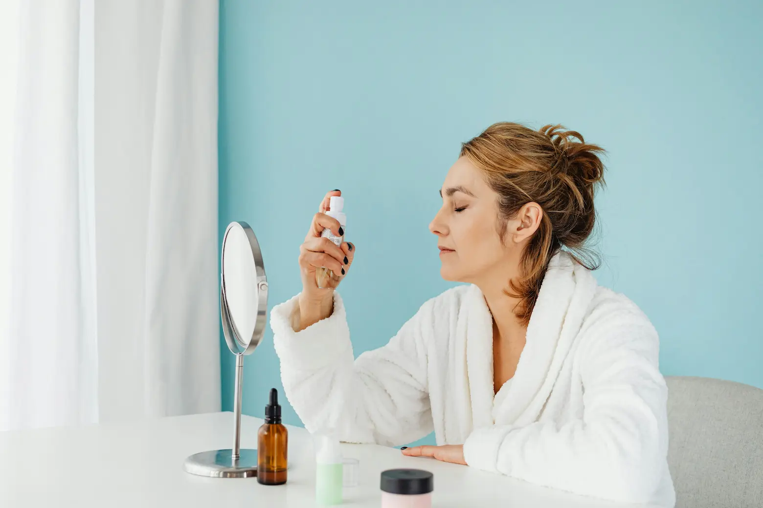 Reapply sunscreen over makeup in a sunlit room
