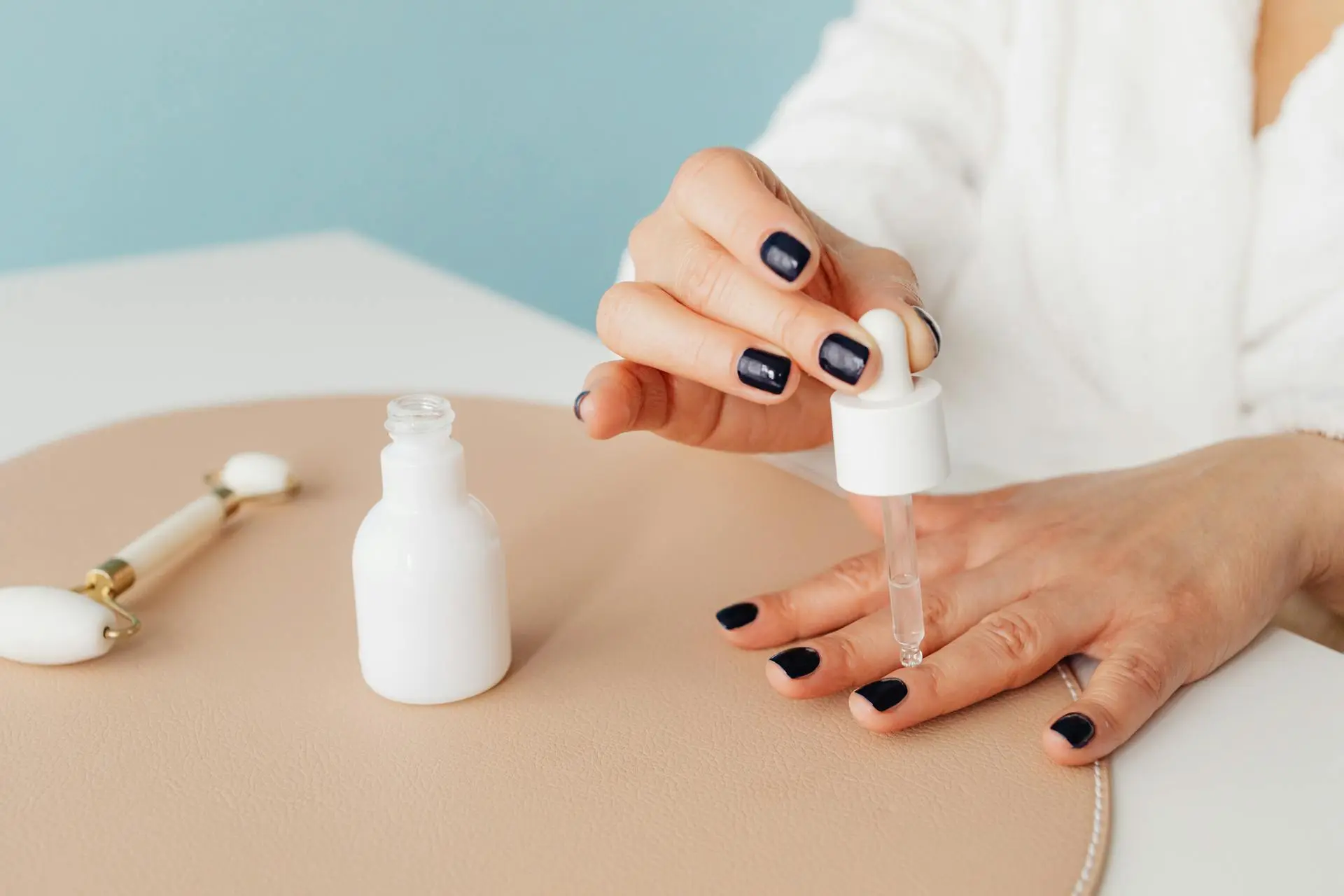 Woman massaging cuticle oil into her nails for hydration